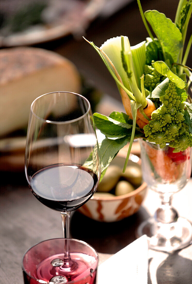 Red wine glass with vegetables in an other glass