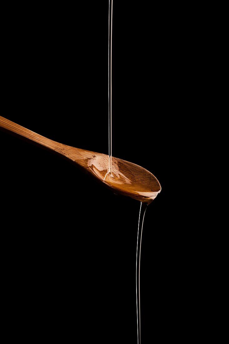 Composition: oil running on a spoon