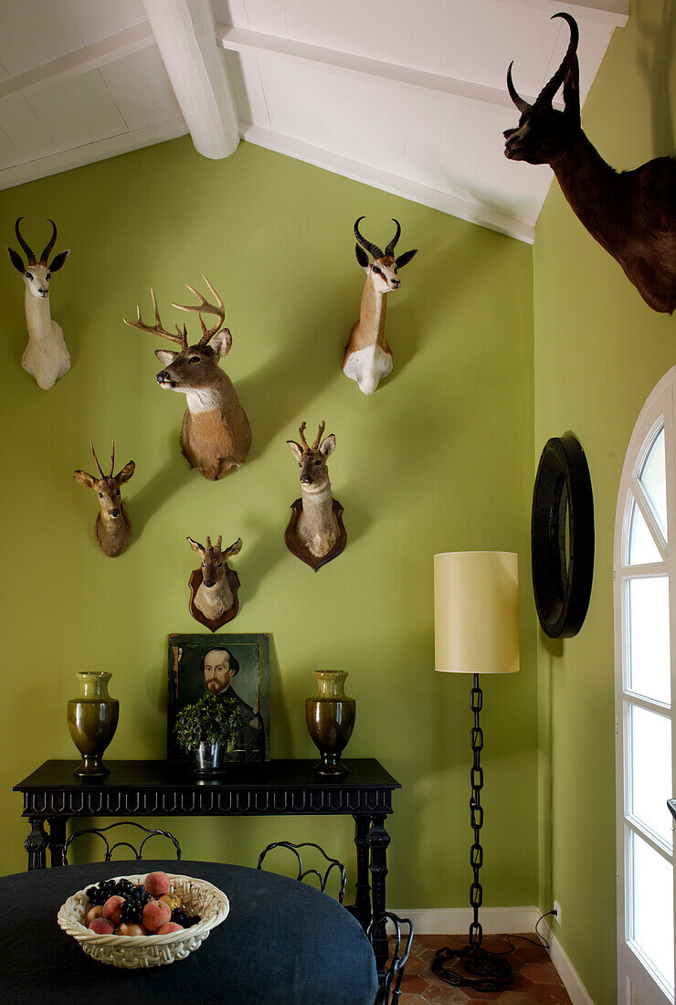 Green Dining room with hunting trophies on the walls