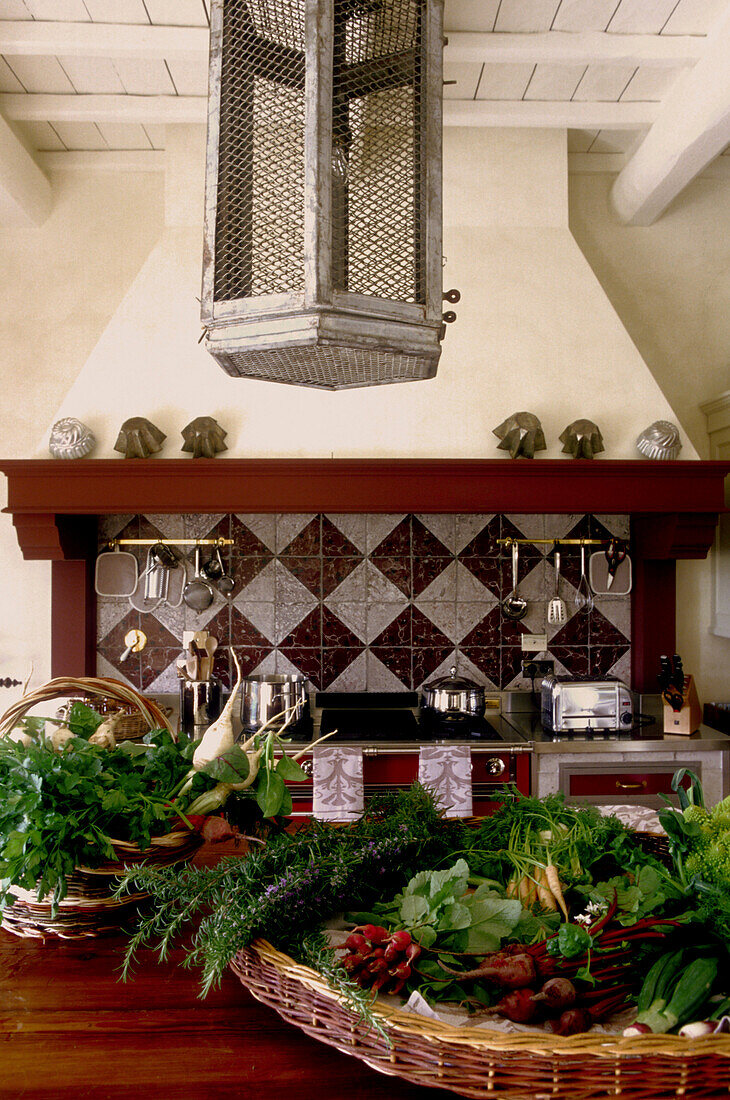 White tuscan style kitchen with baskets of vegetables on a table