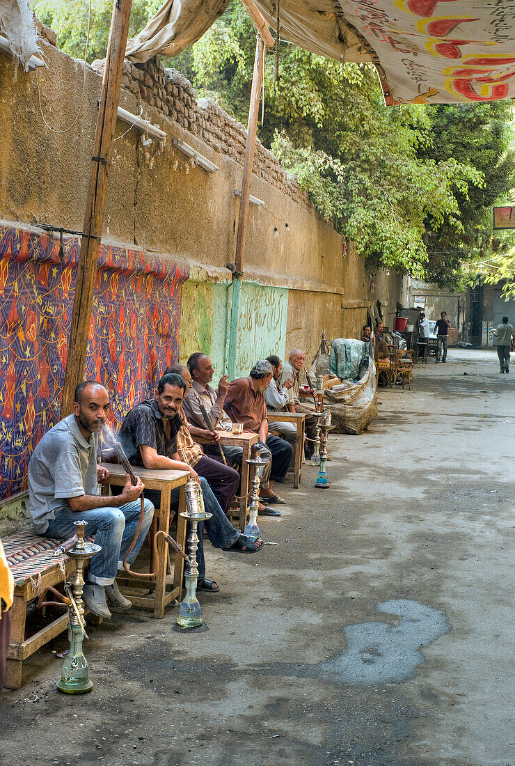 Arab Republic of Egypt, Cairo, The Islamic District, People smoking water pipes in the street