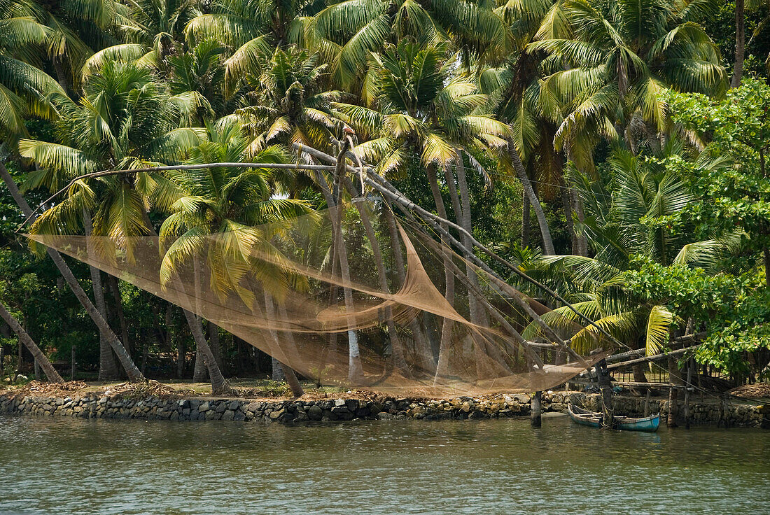 Republic of India, Kerala State, Fishing net hanging over the water, palm trees