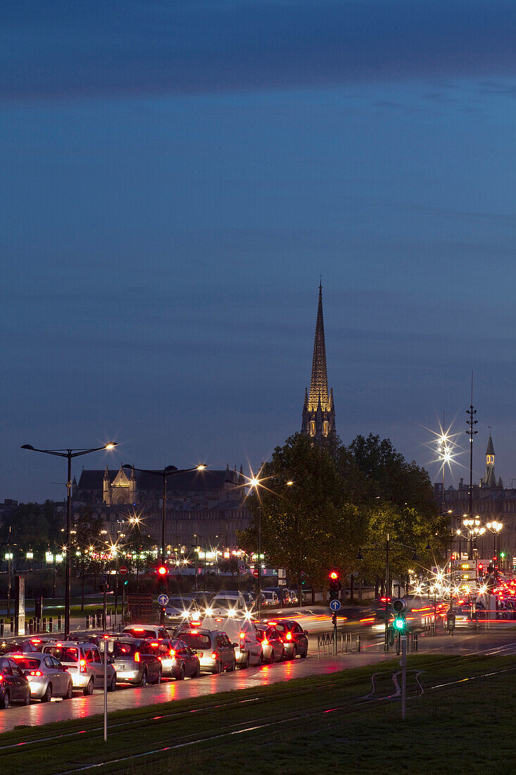 France, Bordeaux, Southwestern France, Aquitaine, Quai de la Douane, road traffic at dusk, St Michel's Church in the background