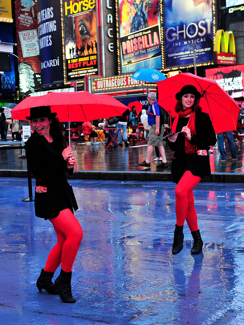 Two womens with red umbrella in Times Square, New York City, New York State, United State, USA