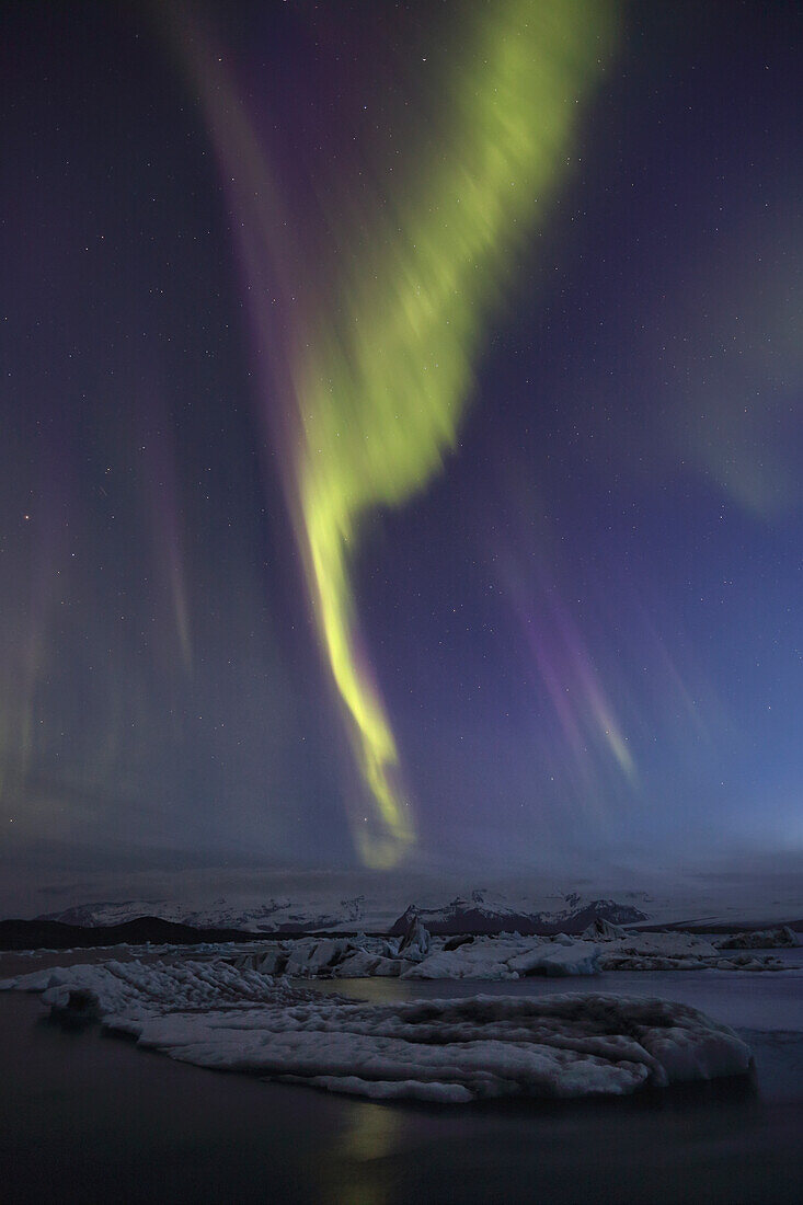 Aurora borealis dances over the glacial lagoon jokulsarlon, iceland