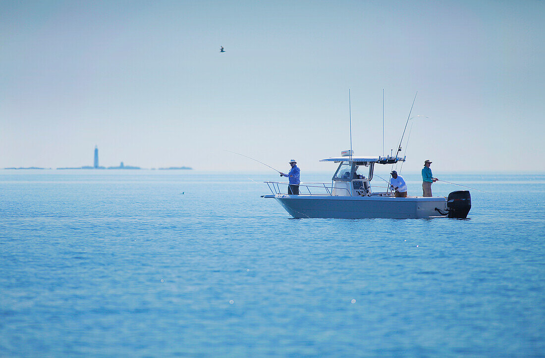 Men fishing from boat in boston harbor, boston massachusetts usa