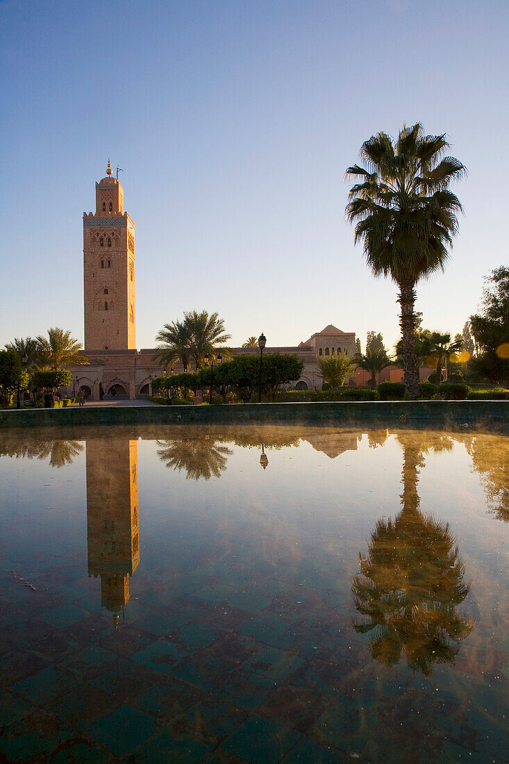 Minaret Of Koutoubia Mosque And Palm Tree Reflected In Fountain At Dawn, Marrakesh,Morocco