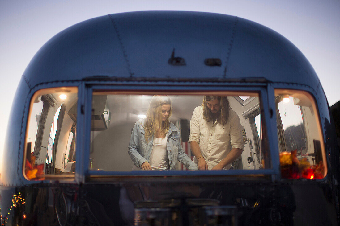 Couple cooking together in trailer