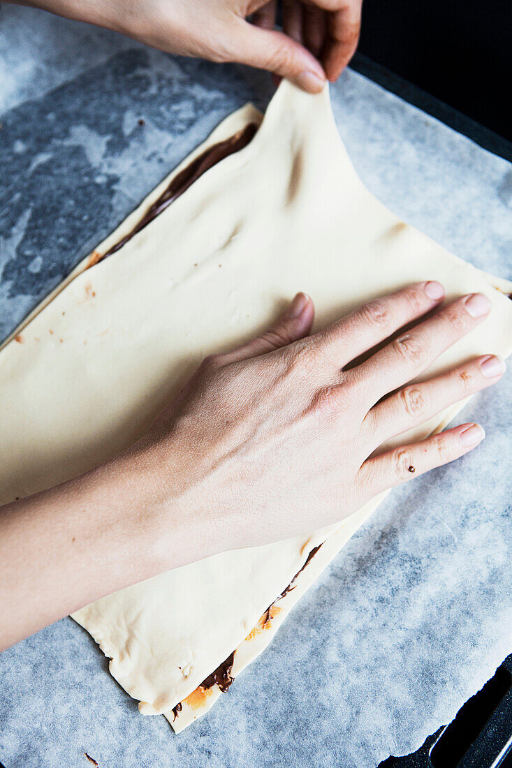 Woman making cake with chocolate spread