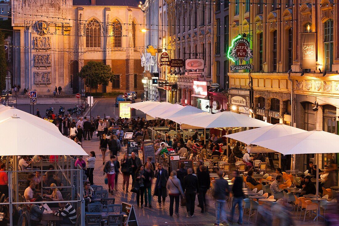 France, Nord-Pas de Calais Region, Nord Department, French Flanders Area, Lille, Grand Place-Place General de Gaulle, cafes and crowds, dusk, NR