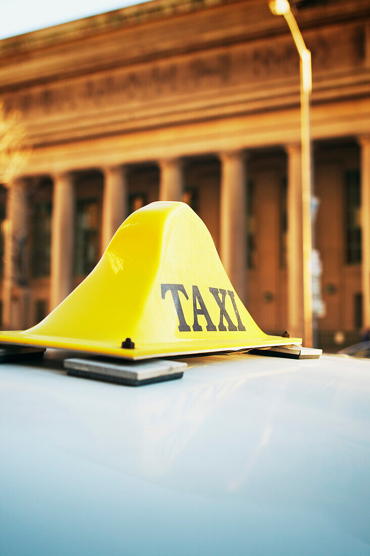 Taxi Sign on Roof of Car