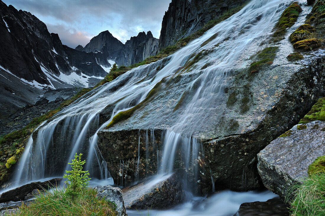 Flowing water from creek creating mini waterfall, Cirque of Unclimbables, Nahanni National Park, Northwest Territories