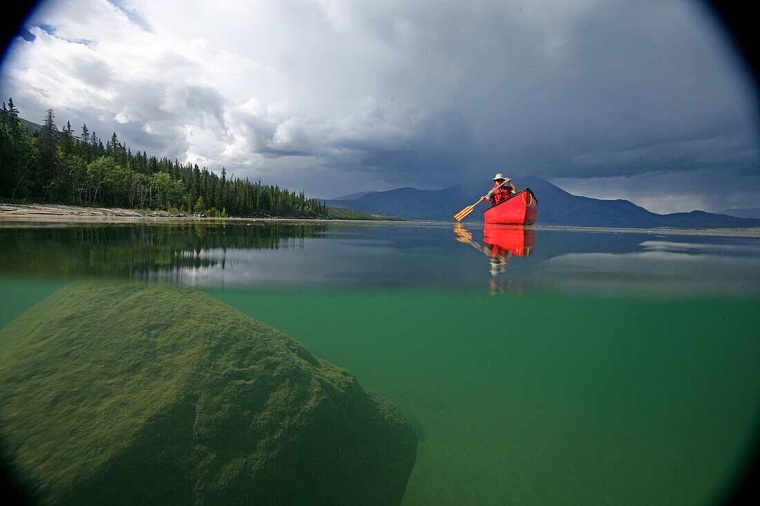 Vignetted Underwater Image of a Man Canoeing on Kusawa Lake, Yukon