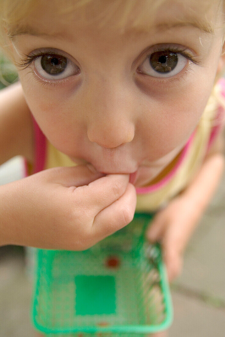 Close Up of a Little Girl Eating a Raspberry, Toronto, Ontario