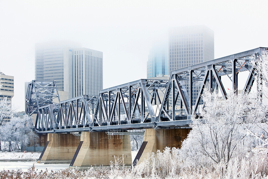 Downtown and railbridge crossing Red River on frosty winter day, Winnipeg, Manitoba