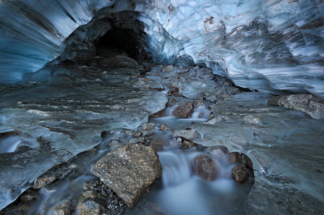 Glacial creek flowing from blue ice cave in Britnell Glacier, Nahanni National Park, Northwest Territories