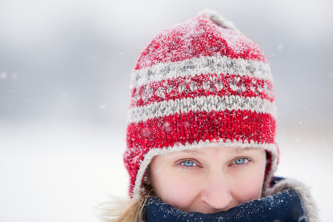 Woman bundled up, wearing toque on snowy winter day, Winnipeg, Manitoba