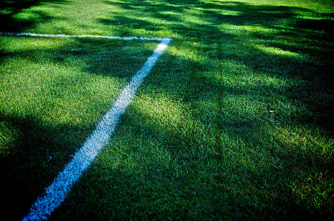 Chalk lines on the green grass of a football field, Otterburn park, Quebec