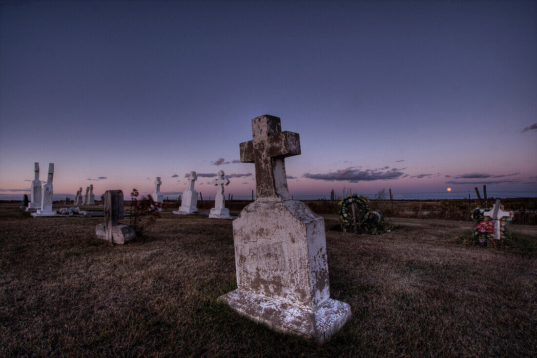 Sunset over a country cemetery in the hamlet of Fedora, Alberta