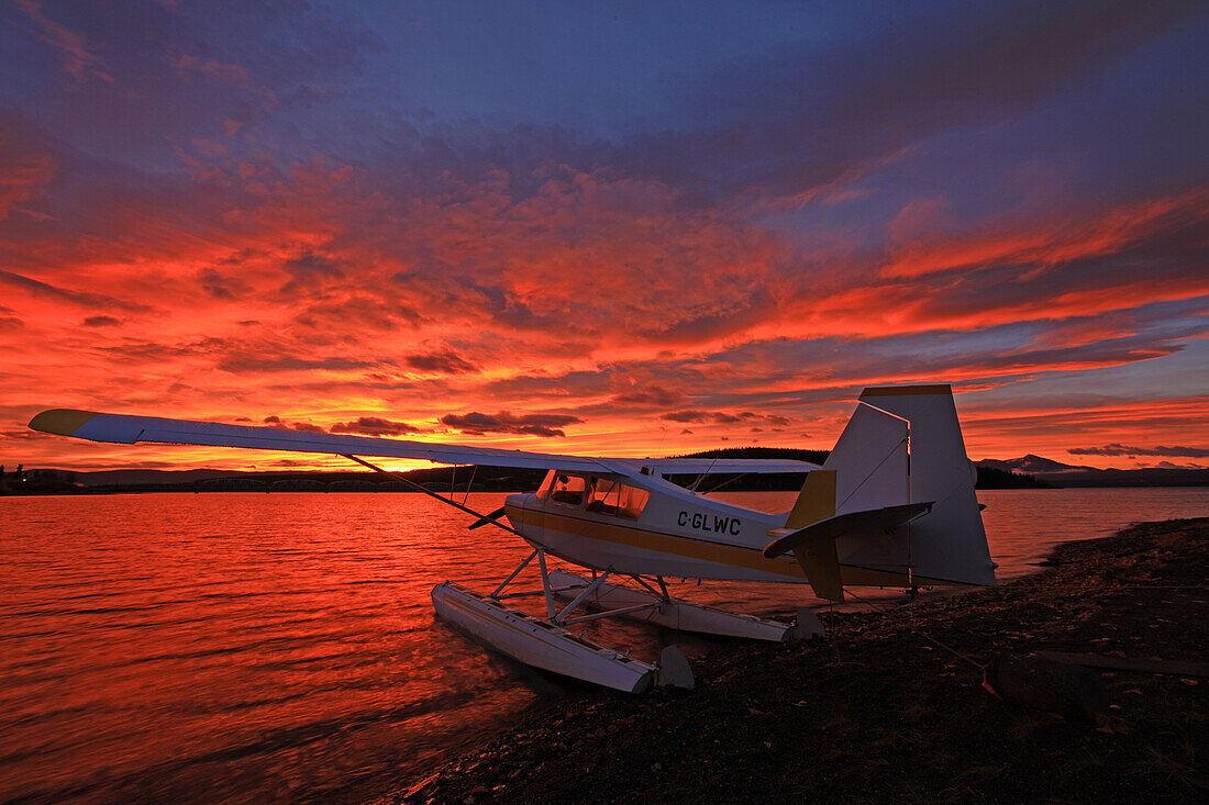 A float plane facing the sunrise over Teslin Lake, Yukon