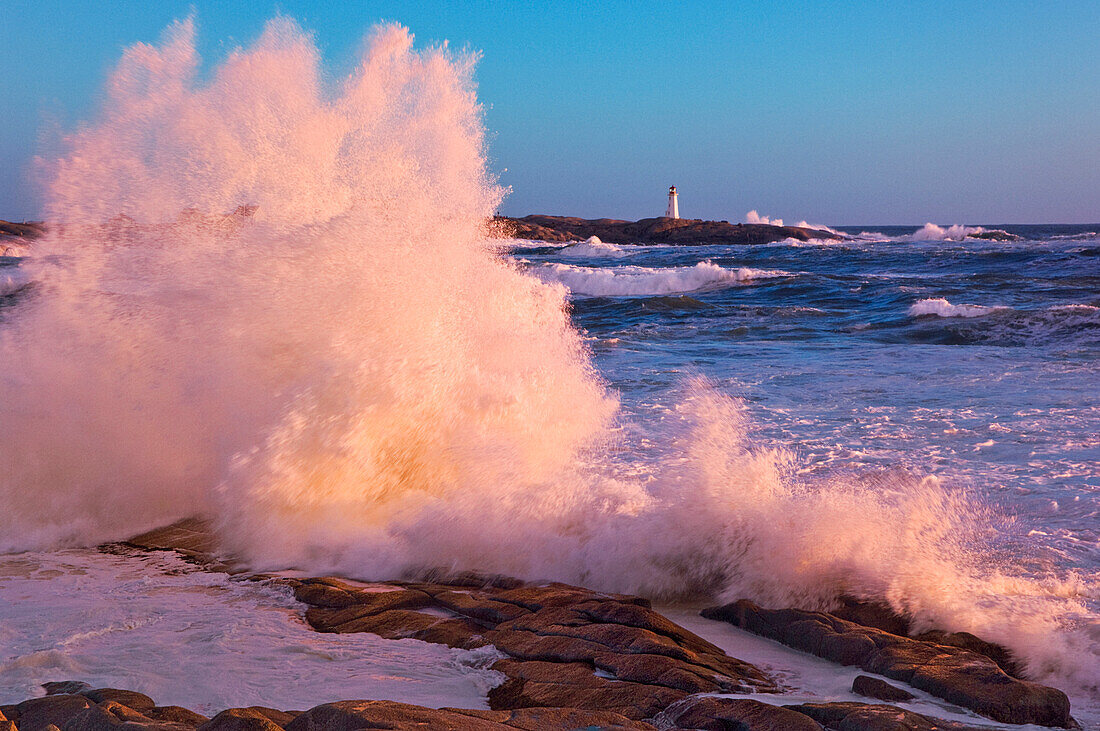 Strong Winds blow Waves onto Rocks in front of Lighthouse at Peggy's Cove, Nova Scotia