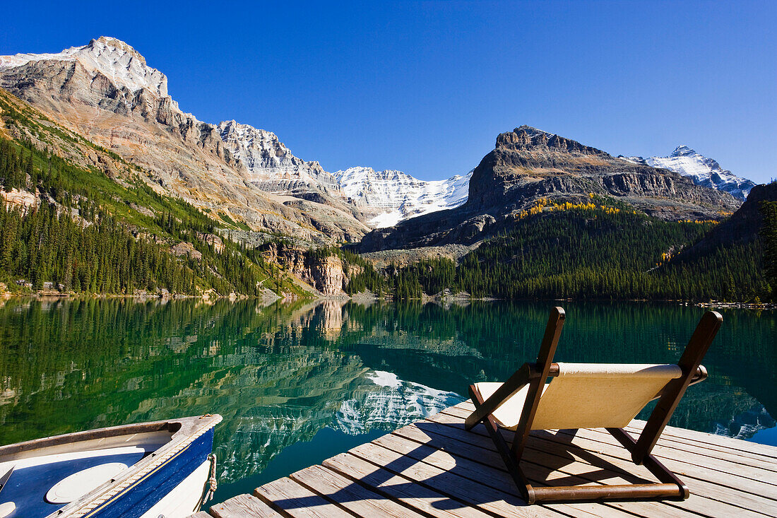Chair on a dock, Lake O'Hara and Mountains, Yoho National Park, British Columbia