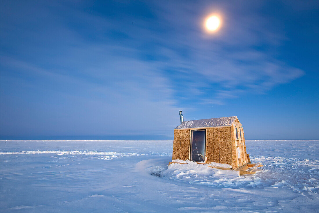 Ice Fishing hut under moonlight on frozen Lake Winnipeg, Gimli, Manitoba