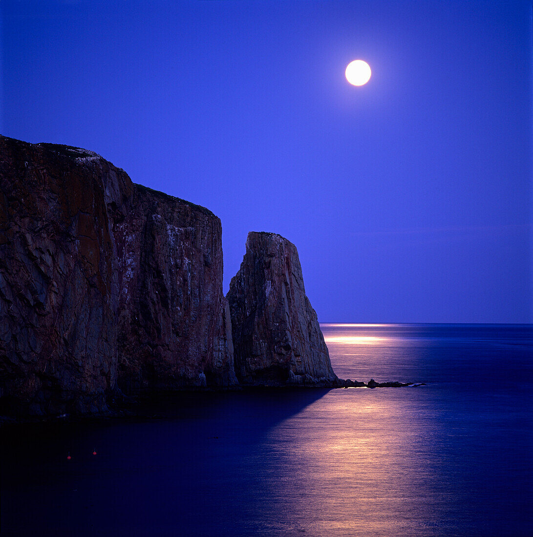 Moon at dusk on Perce Rock, Gaspe Coast, Quebec