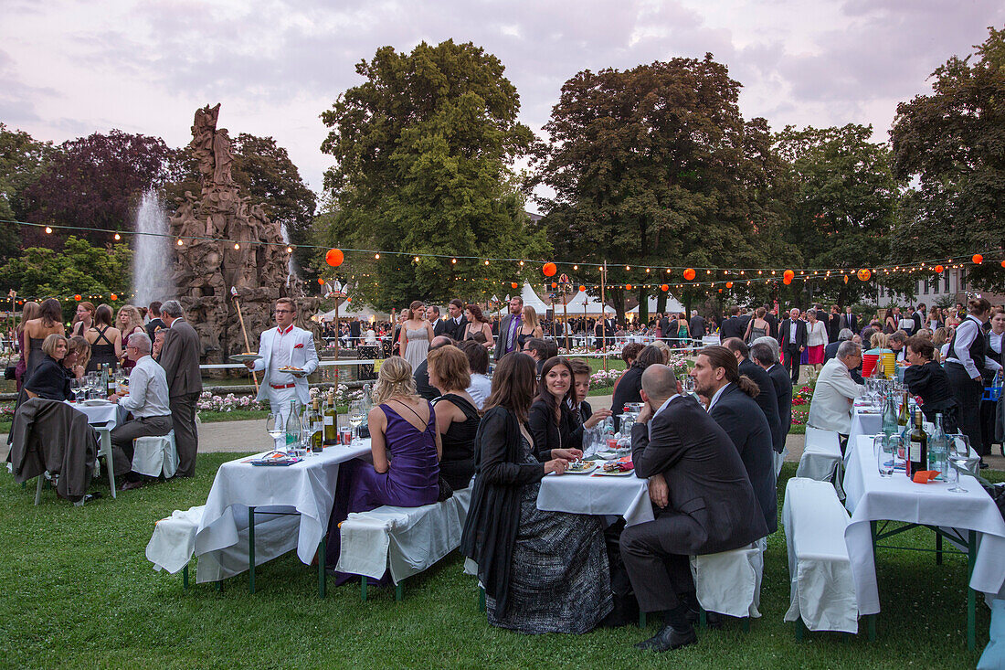 People enjoying the formal ball in the castle gardens, hosted by Erlangen University, Erlangen, Franconia, Bavaria, Germany