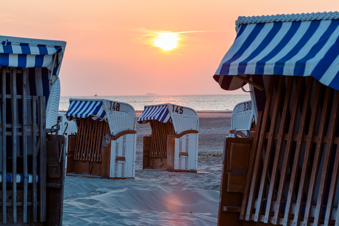 Beach chairs on the beach at sunset, Spiekeroog Island, North Sea, East Frisian Islands, East Frisia, Lower Saxony, Germany, Europe