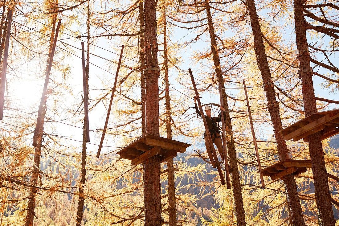Woman in a high ropes course, Vernagt am See, Schnals Valley, South Tyrol, Italy