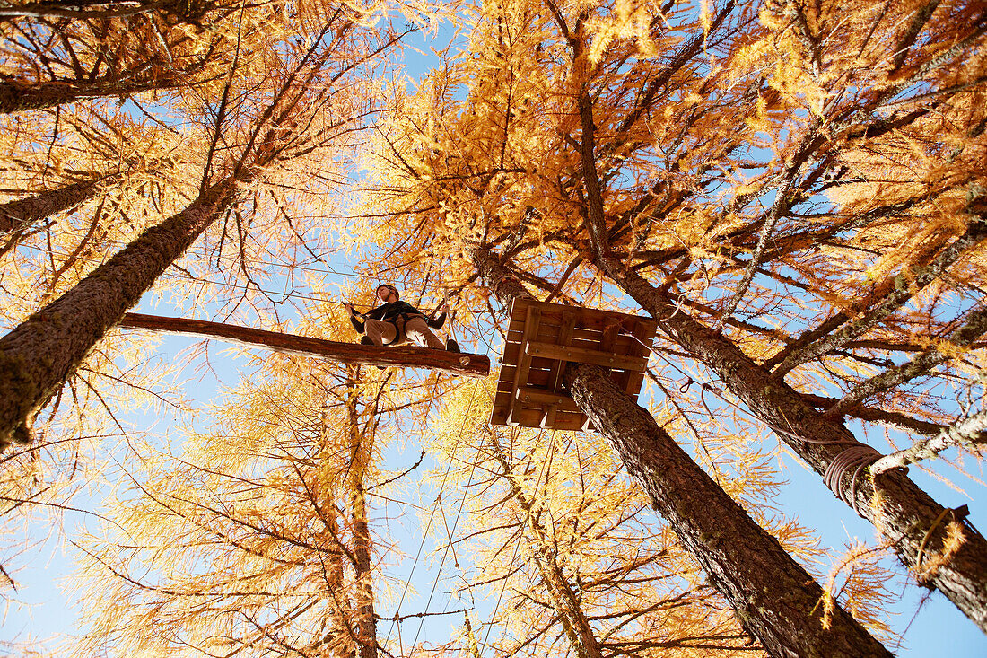 Woman in a high ropes course, Vernagt am See, Schnals Valley, South Tyrol, Italy