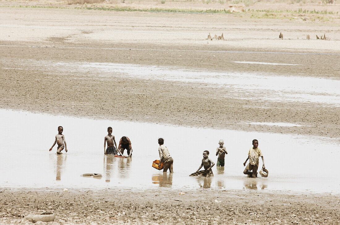 Children fishing in a waterhole, Benin