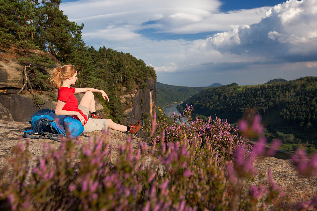 Young woman enjoying view over river Elbe, Saxon Switzerland National Park, Saxony, Germany