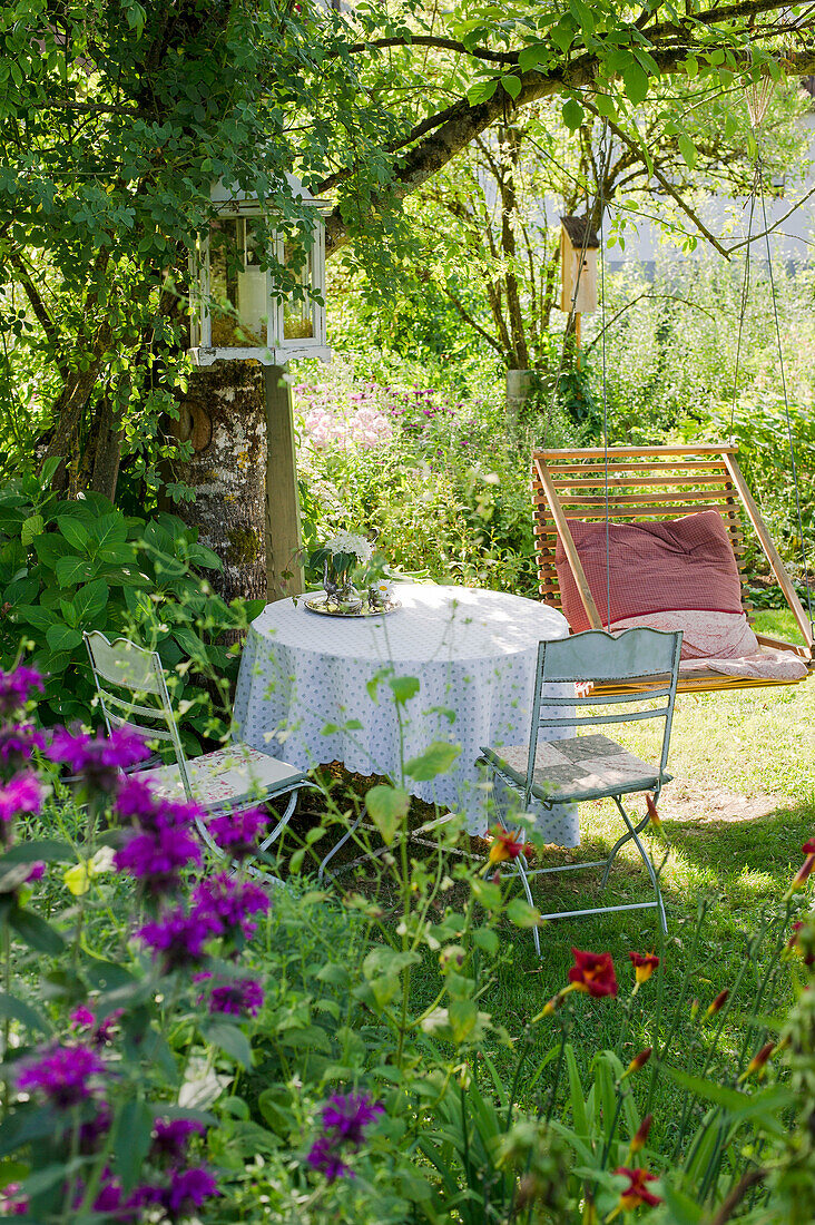 Garden still life with table and chairs and summer flowers, Freiamt, Emmendingen, Baden-Wuerttemberg, Germany