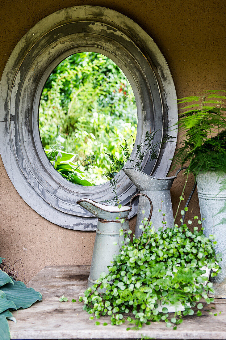 Garden still life with antique mirror and milk jugs, Freiamt, Emmendingen, Baden-Wuerttemberg, Germany