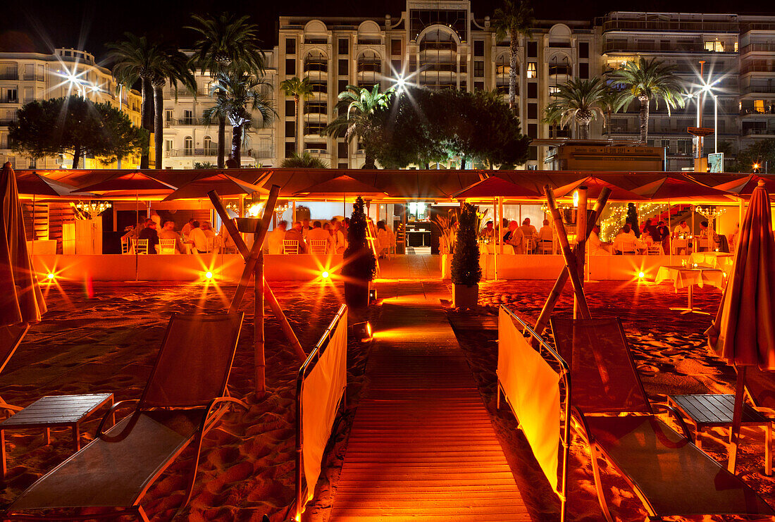 Restaurant on the beach in the evening light, Cannes, Provence, France