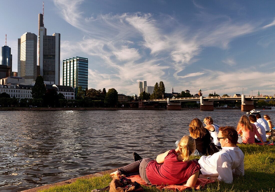 People relaxing on the banks of the river Main, Frankfurt am Main, Hessen, Germany