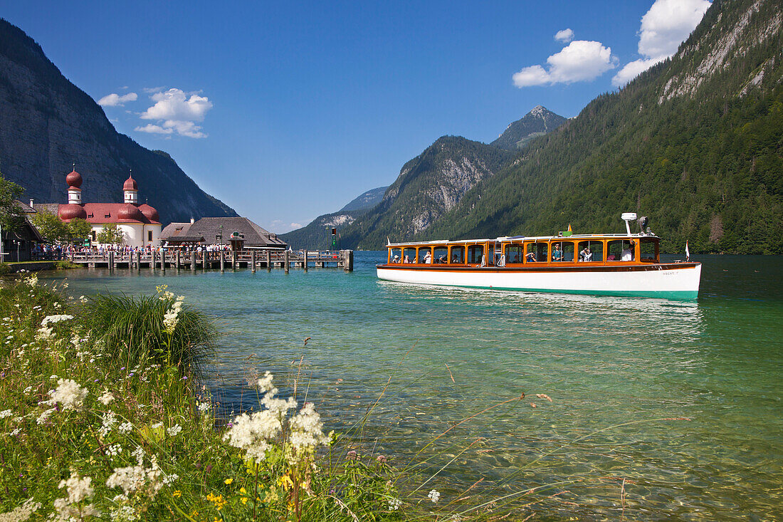 Excursion boat in front of baroque style pilgrimage church St Bartholomae, Koenigssee, Berchtesgaden region, Berchtesgaden National Park, Upper Bavaria, Germany