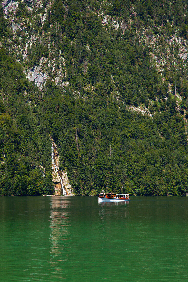 Excursion boat at Schrainbach waterfall, Koenigssee, Berchtesgaden region, Berchtesgaden National Park, Upper Bavaria, Germany