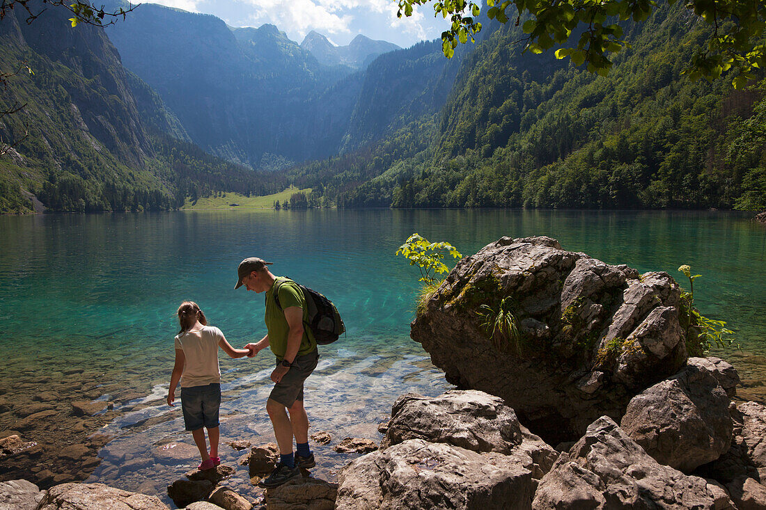 Father and daughter at Obersee, Koenigssee, Berchtesgaden region, Berchtesgaden National Park, Upper Bavaria, Germany