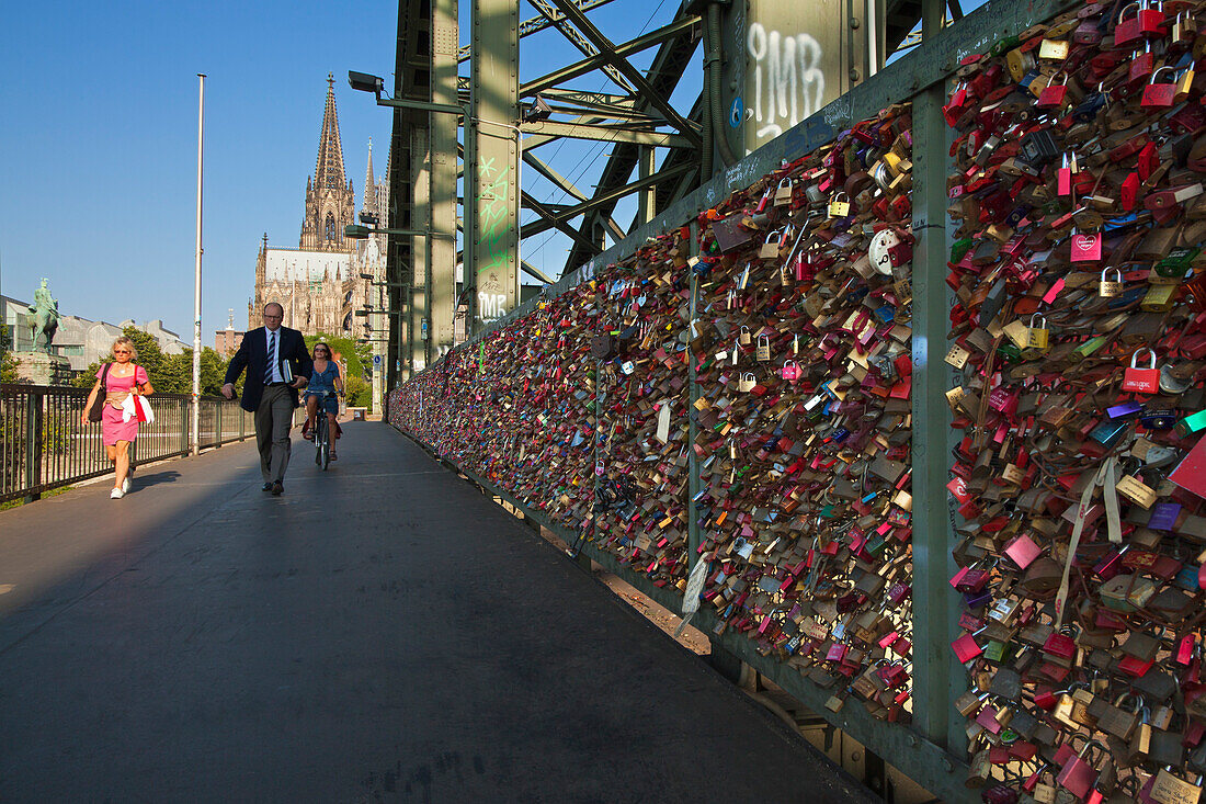 Love locks on Hohenzollern bridge, view to Cologne cathedral, Cologne, Rhine river, North Rhine-Westphalia, Germany