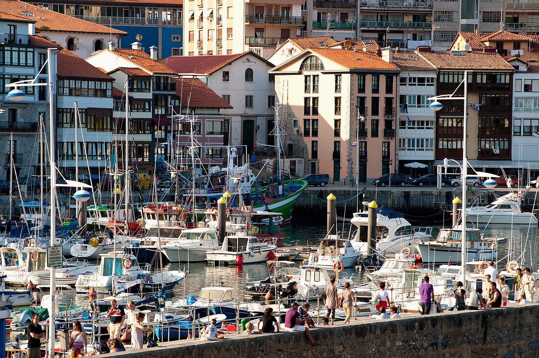 Incidental People At Lekeitio Harbor, Basque Country, Spain