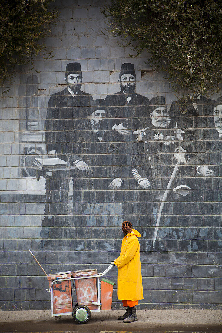 Street Cleaner In Front Of Mural Of Famous Kurdish People, Sulaymaniyah, Iraqi Kurdistan, Iraq