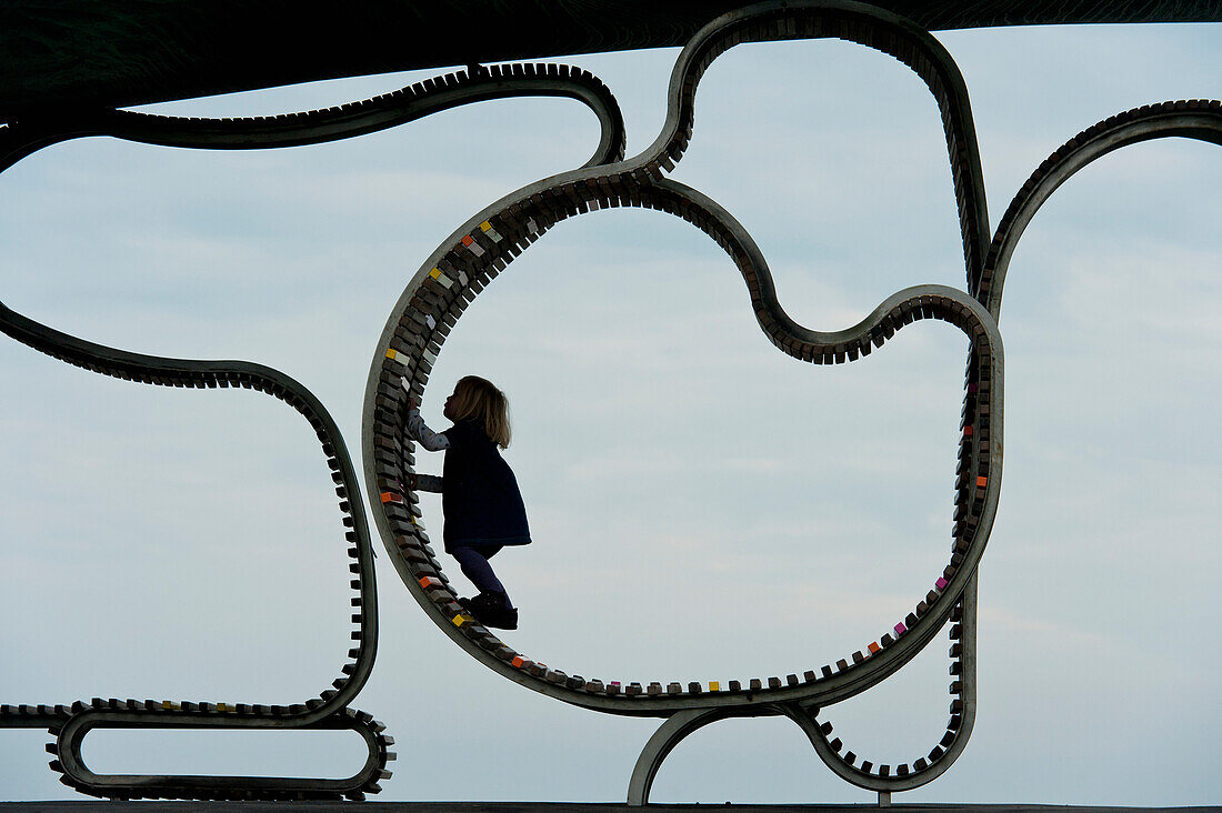 Girl Climbing On 'the Longest Bench', Littlehampton, West Sussex, Uk