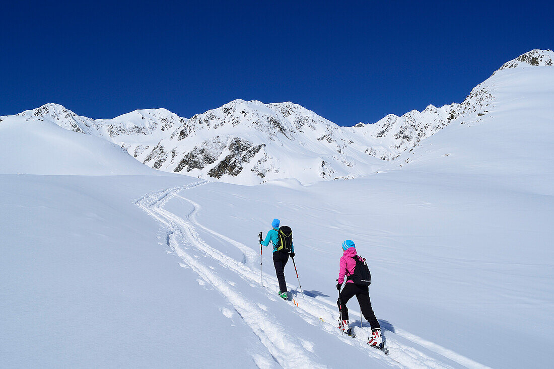 Two female backcountry skiers ascending to Gleirscher Rosskogel, Pforzheim Hut, Sellrain, Stubai Alps, Tyrol, Austria