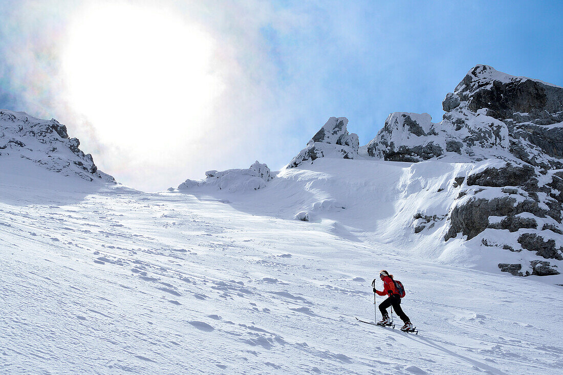 Female backcountry skier ascending to Hocheisspitze, Berchtesgaden Alps, Upper Bavaria, Bavaria, Germany