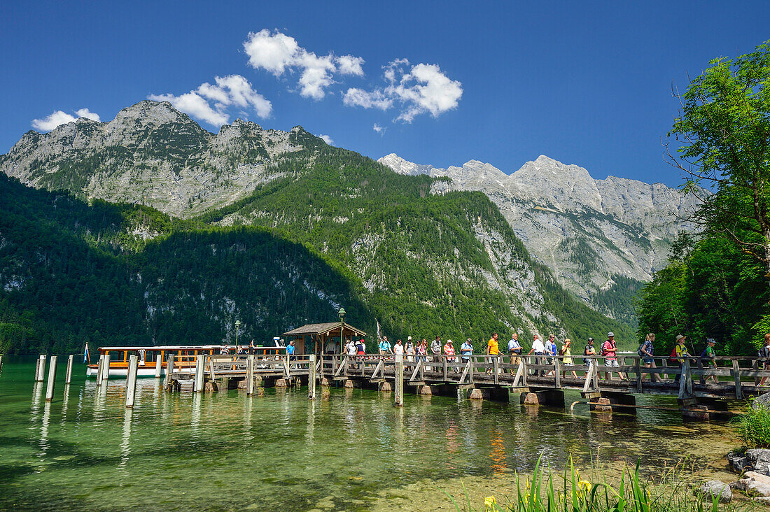 People leaving boat and walking on landing stage, Salet, lake Koenigssee, Berchtesgaden range, National Park Berchtesgaden, Berchtesgaden, Upper Bavaria, Bavaria, Germany