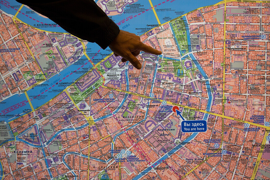 Man's hand pointing to an illuminated city map, St. Petersburg, Russia, Europe