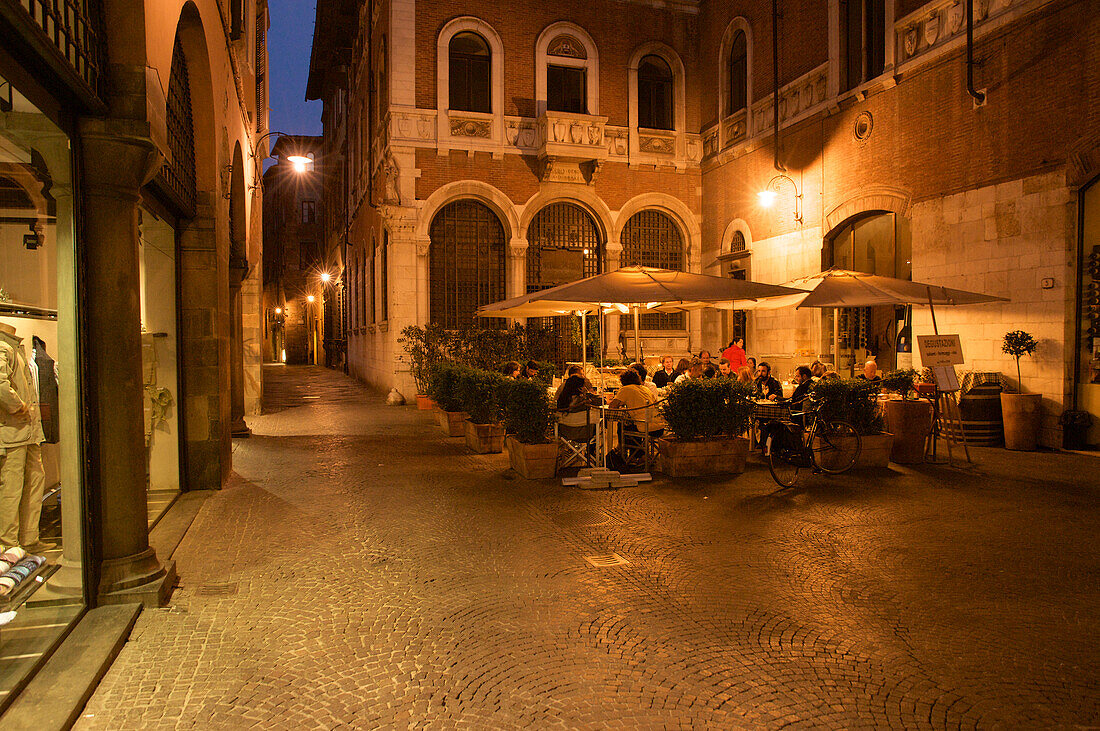 Restaurant with outdoor tables in the evening light, Lucca, Tuscany, Italy